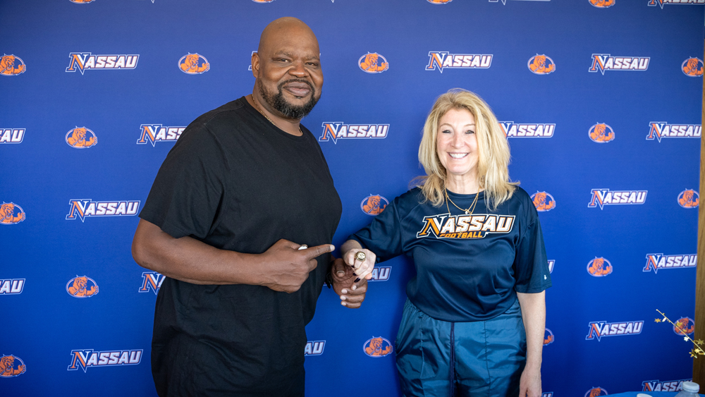 NCC Alumnus and Super Bowl Champion Gary Brown shares his Super Bowl ring with NCC Interim-President Dr. Maria Conzatti.