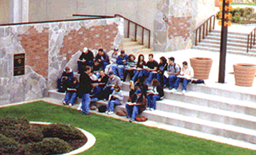 Students in front of Inscription Brick Wall