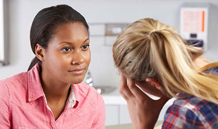 Woman speaking with a student