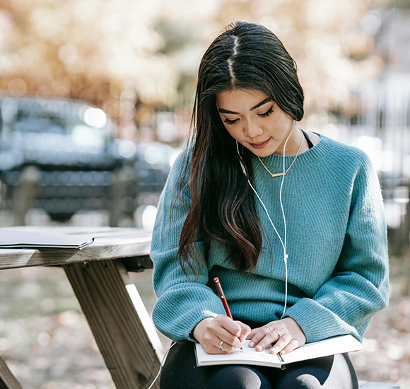 Student Writing into a Book