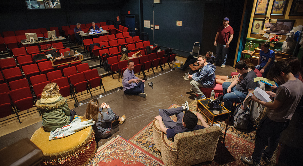 Students on stage creating the sets 