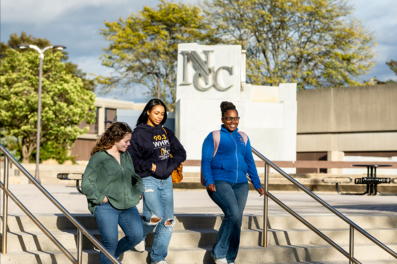 Student Walking In Front Of Fountain